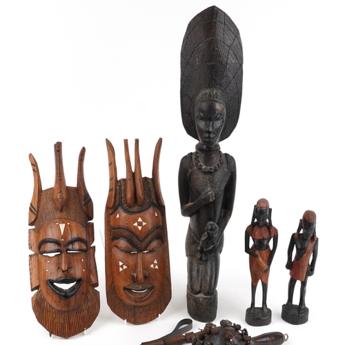 2491 - Tribal hardwood carvings including a large heavy figure of a mother with child and a carved bone nec... 