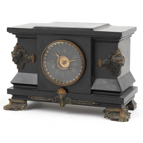 2445 - Victorian black slate mantle clock striking on a gong with bronze mounts and applied masks, the circ... 