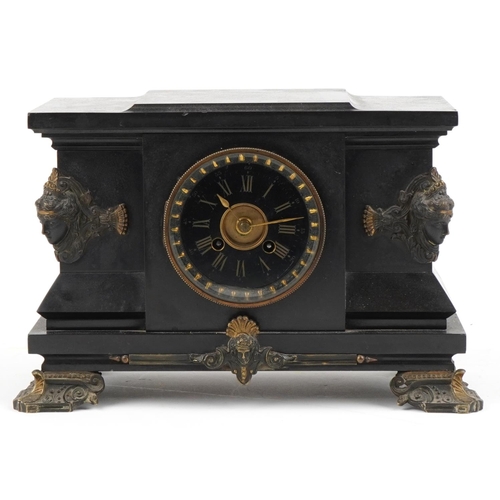 2445 - Victorian black slate mantle clock striking on a gong with bronze mounts and applied masks, the circ... 