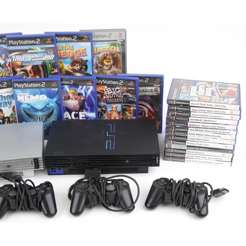 1213 - Two Sony PlayStation 2 games consoles with controllers and various games including League of Speed, ... 