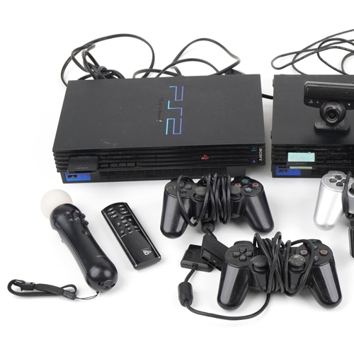 1209 - Three PlayStation 2 games consoles with controllers and accessories