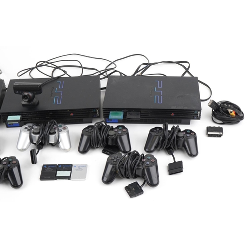 1209 - Three PlayStation 2 games consoles with controllers and accessories