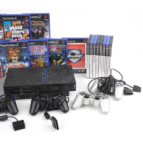 1217 - Two Sony PlayStation 2 games consoles with controllers and various games including Spiro and Grand T... 