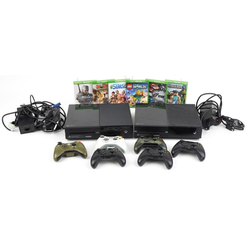 Two Microsoft Xbox 1 games consoles with various controllers and games including Worms and Minecraft