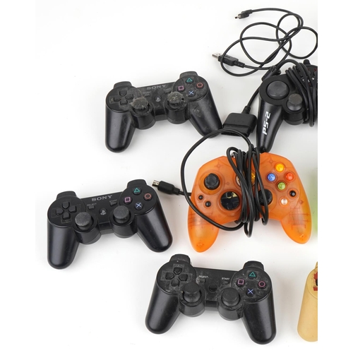 1223 - Various games console controllers including Sony PlayStation and Microsoft Xbox