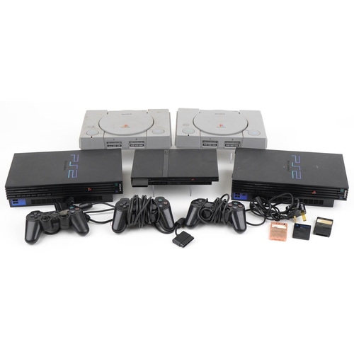 1214 - Five Sony games consoles with three controllers including two PlayStation 1s and three PlayStation 2... 