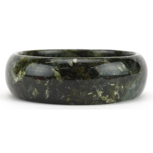 3573 - Chinese green agate bangle, 7.5cm in diameter