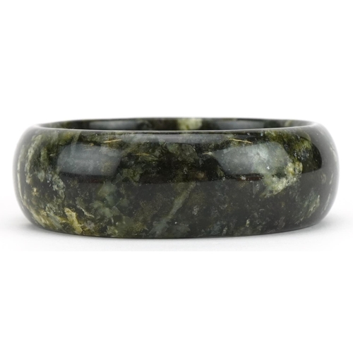 3573 - Chinese green agate bangle, 7.5cm in diameter