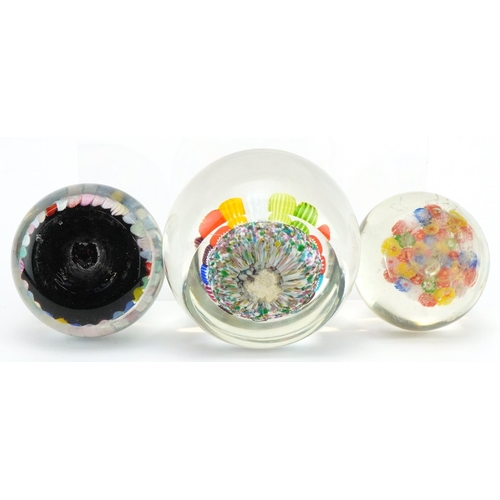 2307 - Three 20th century millefiori glass paperweights, the largest 7cm high