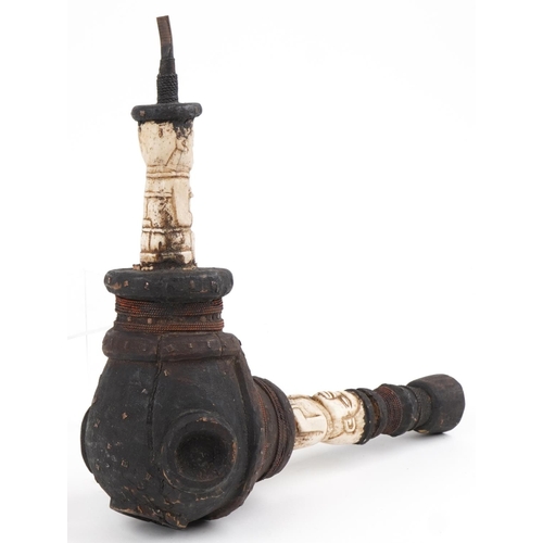 416 - African tribal interest smoking pipe with carved bone figural mounts, 38cm in length