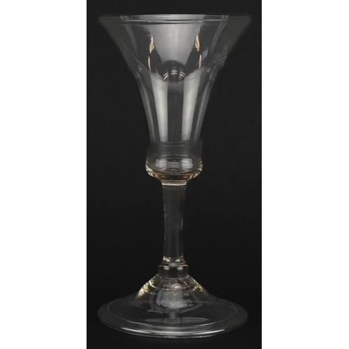 516 - 18th century wine glass with bell shaped bowl on folded foot, 15cm high