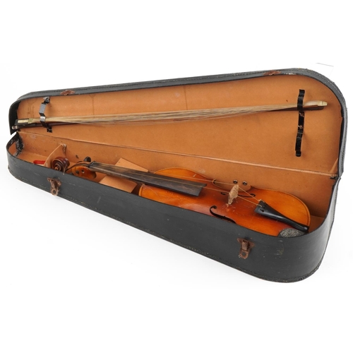 1013 - Old wooden violin with violin bow and case, the violin bearing an Antonio Stradivarius label, the vi... 