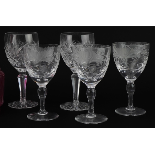 2296 - Cut glassware including set of six good quality wine glasses etched with flowers and a cranberry gla... 