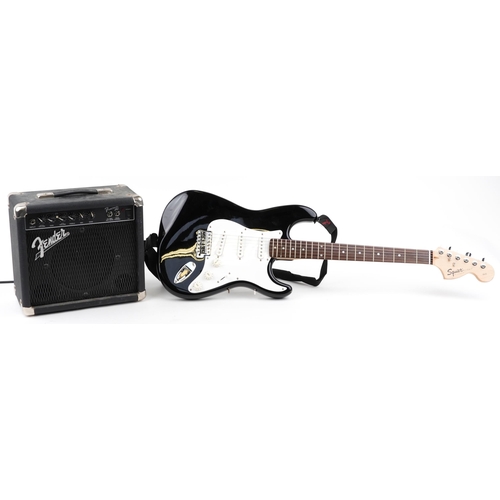 1007 - Squire Strat by Fender six string electric guitar with Fender Front Man amp and protective travel ca... 