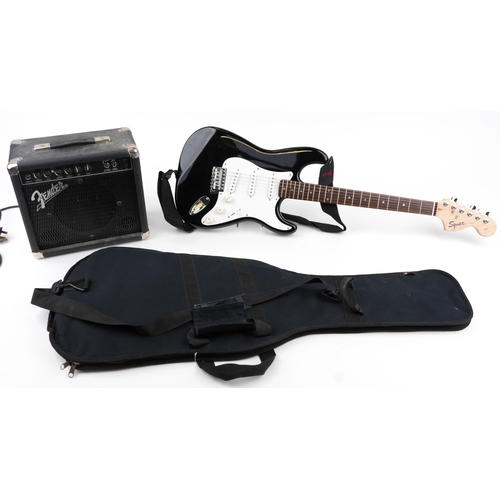 1007 - Squire Strat by Fender six string electric guitar with Fender Front Man amp and protective travel ca... 