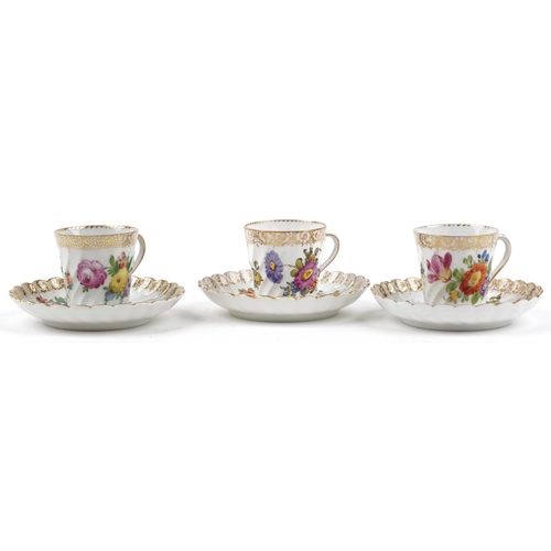 2407 - Dresden, three German porcelain writhen cups with saucers hand painted with flowers, each cup 6cm hi... 