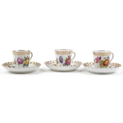 2407 - Dresden, three German porcelain writhen cups with saucers hand painted with flowers, each cup 6cm hi... 