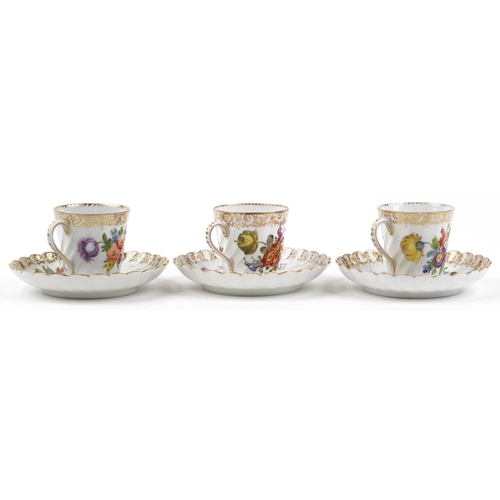 2407 - Dresden, three German porcelain writhen cups with saucers hand painted with flowers, each cup 6cm hi... 