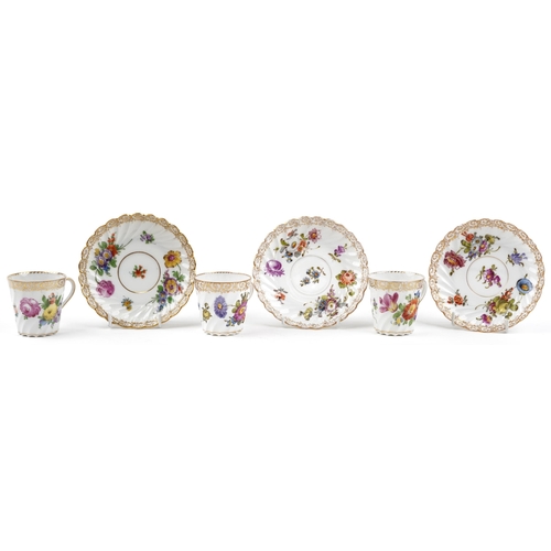 2407 - Dresden, three German porcelain writhen cups with saucers hand painted with flowers, each cup 6cm hi... 