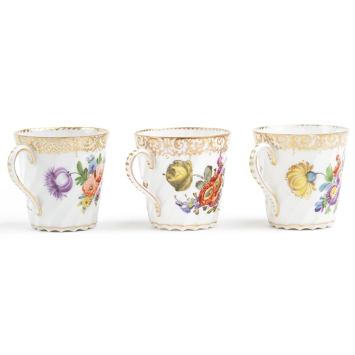 2407 - Dresden, three German porcelain writhen cups with saucers hand painted with flowers, each cup 6cm hi... 