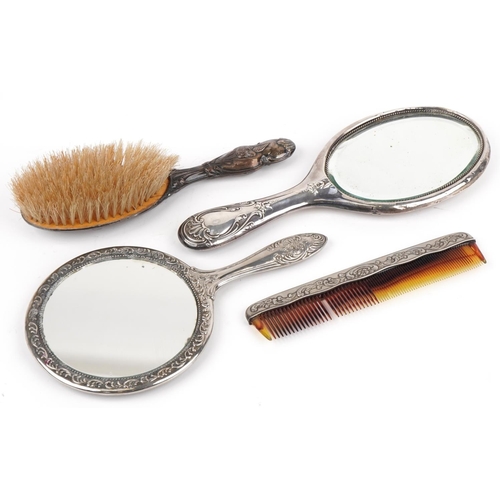 638 - Four dressing table vanity items including silver mounted hand mirror and brush embossed with Putti,... 