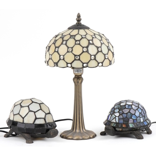 2676 - Three Tiffany design table lamps including two bronzed examples in the form of tortoises, the larges... 