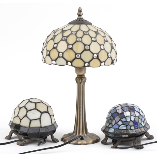 2676 - Three Tiffany design table lamps including two bronzed examples in the form of tortoises, the larges... 