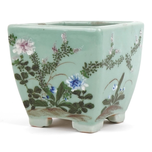 670 - Chinese porcelain celadon glazed four footed planter hand painted with flowers, 16.5cm high