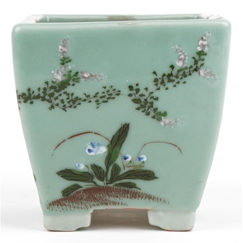 670 - Chinese porcelain celadon glazed four footed planter hand painted with flowers, 16.5cm high