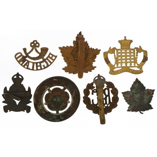 1386 - Seven military interest cap badges including Royal Flying Corps, York & Lancaster, Royal Gloucesters... 