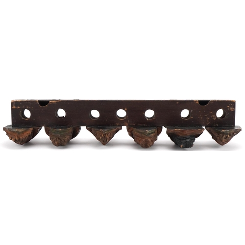 1327 - 19th century treen seven section wall mounted pipe rack carved with six meerschaum heads, 41cm wide