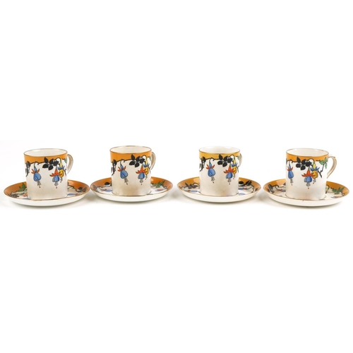 2511 - Four Foley china coffee cans with saucers decorated with stylised fruit, 6cm high