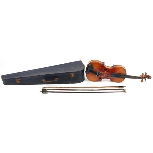 1014 - Old wooden violin with three bows and case, the violin back impressed Stainer, 14.25 inches in lengt... 