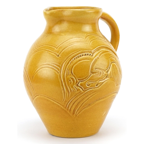 328 - Early 20th century Susie Cooper green glazed jug incised with two stylised leaping deer, 22cm high