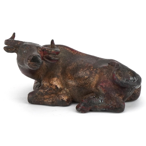 2632 - Chino Tibetan gilt and red lacquered bronze water buffalo, 19cm in length