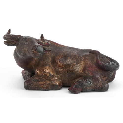 2632 - Chino Tibetan gilt and red lacquered bronze water buffalo, 19cm in length