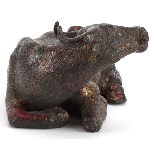 2632 - Chino Tibetan gilt and red lacquered bronze water buffalo, 19cm in length