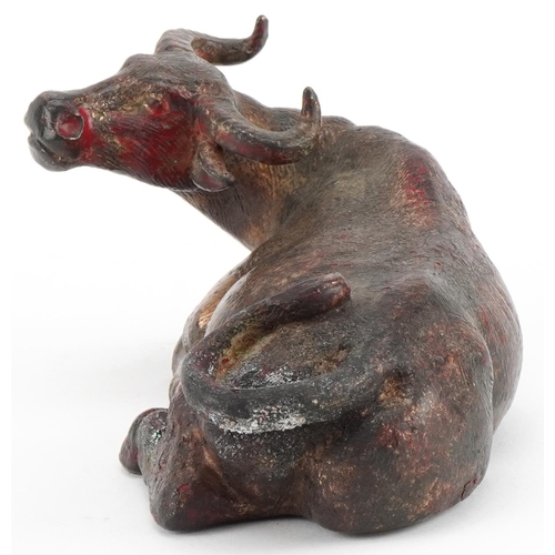 2632 - Chino Tibetan gilt and red lacquered bronze water buffalo, 19cm in length