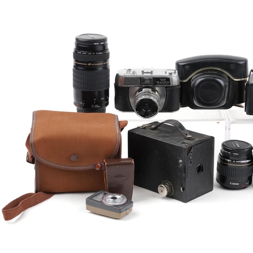 1066 - Vintage and later cameras, lenses and pair of leather bound binoculars, the lenses including Canon Z... 