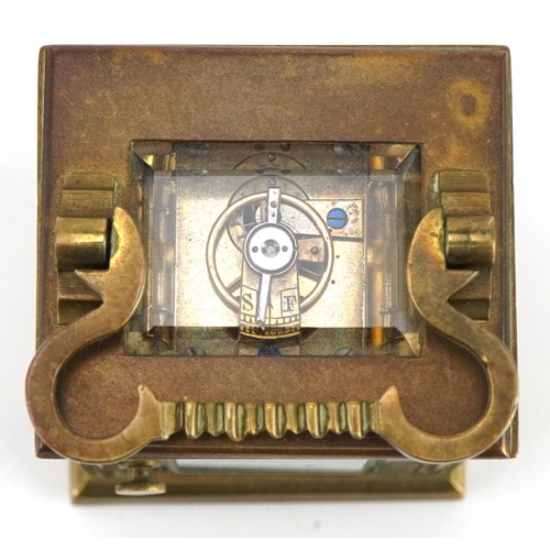 301 - Miniature brass cased carriage clock with case, the circular dial having Roman numerals, the carriag... 