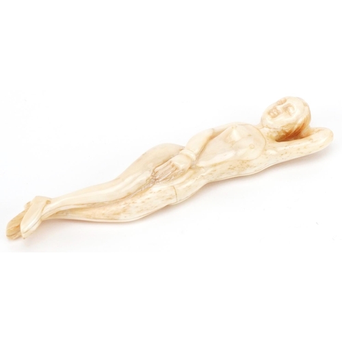 2467 - Scrimshaw style bone carving of a reclining nude female, 13.5cm in length