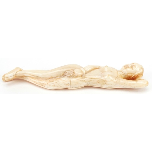 2467 - Scrimshaw style bone carving of a reclining nude female, 13.5cm in length