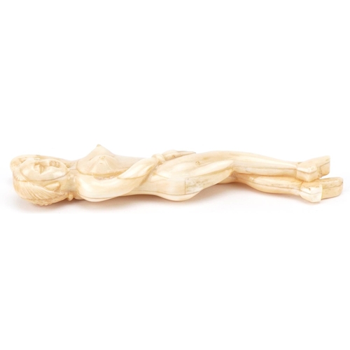 2467 - Scrimshaw style bone carving of a reclining nude female, 13.5cm in length