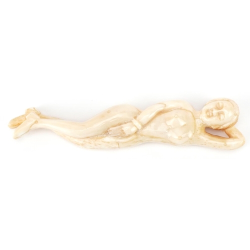 2467 - Scrimshaw style bone carving of a reclining nude female, 13.5cm in length