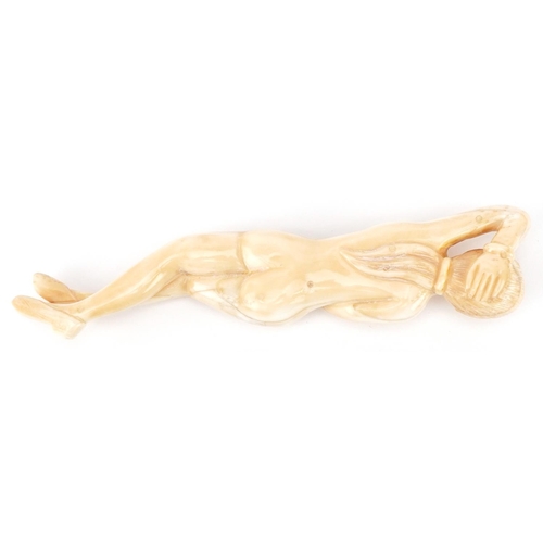 2467 - Scrimshaw style bone carving of a reclining nude female, 13.5cm in length