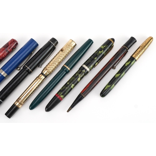 731 - Six vintage fountain pens and propelling pencils, two with gold nibs including a red marbleised exam... 