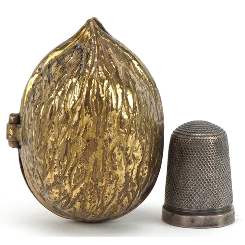 705 - Victorian brass thimble case in the form of an acorn housing a silver thimble, the case 4.5cm high