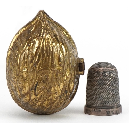 705 - Victorian brass thimble case in the form of an acorn housing a silver thimble, the case 4.5cm high