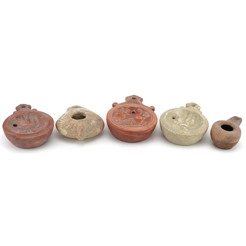 419 - Five Roman style terracotta and pottery oil lamps, the largest 11.5cm in length