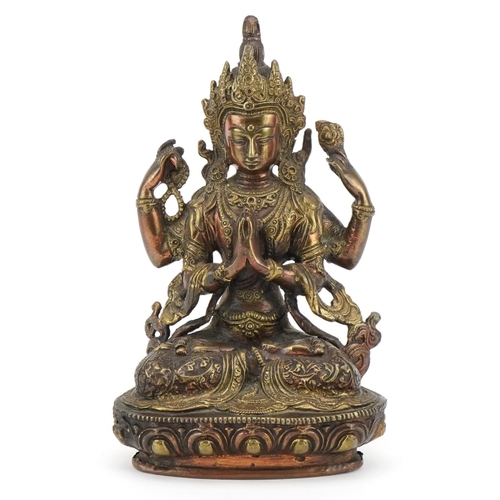 311 - Chino Tibetan partially gilt patinated bronze figure of seated Buddha, 21cm high